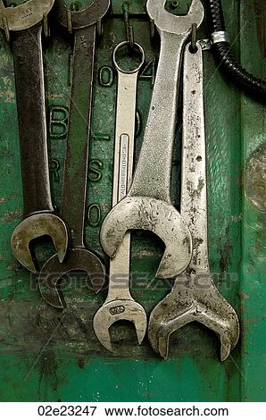 Stock Photo - Five wrenches hanging in machine shop.. Fotosearch