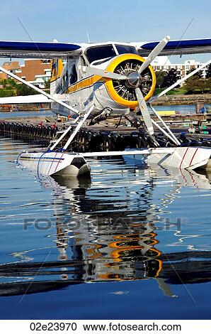Float plane sitting in water next to dock. View Large Photo Image Stock Image - Float plane sitting in water next to dock.. Fotosearch