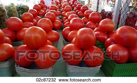 Stock Image - Freshly grown tomatoes on display at a farmer's market.. Fotosearch