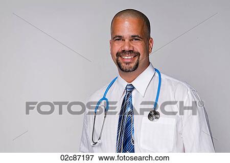 Stock Photo - Friendly family doctor with stethoscope on white background.. Fotosearch