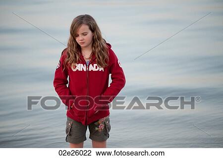 Stock Image - Girl along shoreline in Gimli, Manitoba, Canada. Fotosearch