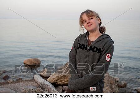 Stock Image - Girl along the shoreline in Gimli, Manitoba, Canada. Fotosearch