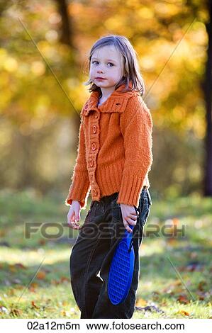 Picture - Girl holding a paddle racket. Fotosearch