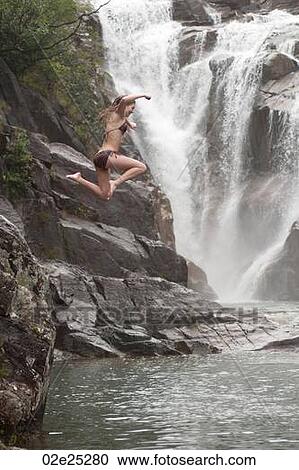 Girl jumping from cliff at Mountain Pine Ridge Reserve, Waterfall View Large Photo Image Stock Image - Girl jumping from cliff at Mountain Pine Ridge Reserve, Waterfall. Fotosearch