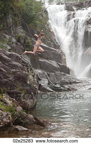 Girl jumping from cliff at Mountain Pine Ridge Reserve, Waterfall View Large Photo Image Stock Image - Girl jumping from cliff at Mountain Pine Ridge Reserve, Waterfall. Fotosearch