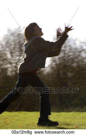 Stock Image - Girl preparing to catch a ball. Fotosearch