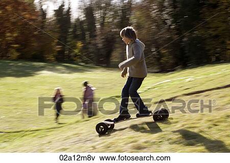 Stock Photo - Girl riding a mountain board. Fotosearch