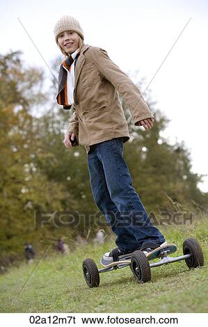 Girl standing on a mountain board View Large Photo Image Stock Photograph - Girl standing on a mountain board. Fotosearch