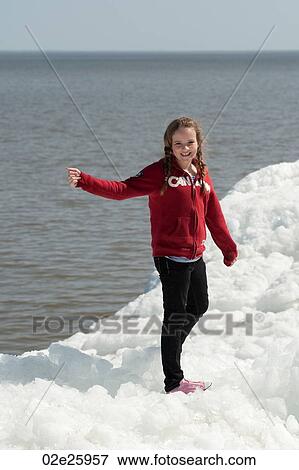 Girl standing on a pile of snow at Winnipeg Beach, Manitoba, Canada View Large Photo Image Stock Photo - Girl standing on a pile of snow at Winnipeg Beach, Manitoba, Canada. Fotosearch
