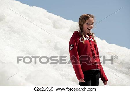 Girl standing on a pile of snow at Winnipeg Beach, Manitoba, Canada View Large Photo Image Stock Photo - Girl standing on a pile of snow at Winnipeg Beach, Manitoba, Canada. Fotosearch