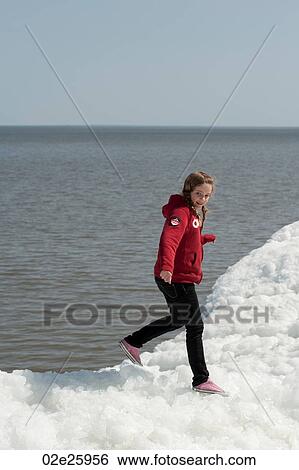 Girl standing on a pile of snow at Winnipeg Beach, Manitoba, Canada View Large Photo Image Stock Photograph - Girl standing on a pile of snow at Winnipeg Beach, Manitoba, Canada. Fotosearch
