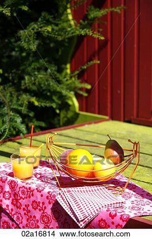 Glasses of orange juice and fruit on a table View Large Photo Image Picture - Glasses of orange juice and fruit on a table. Fotosearch