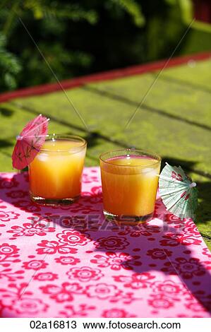 Glasses of orange juice on a table View Large Photo Image Stock Image - Glasses of orange juice on a table. Fotosearch