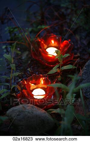 Glowing red candles by water View Large Photo Image Stock Image - Glowing red candles by water. Fotosearch