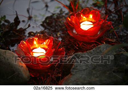 Glowing red candles by water View Large Photo Image Stock Photography - Glowing red candles by water. Fotosearch