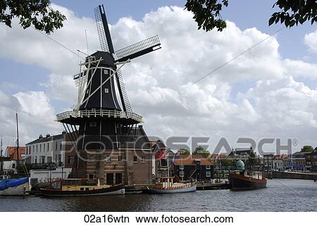 Haarlem canal and De Adriaan windmill, Holland View Large Photo Image Picture - Haarlem canal and De Adriaan windmill, Holland. Fotosearch
