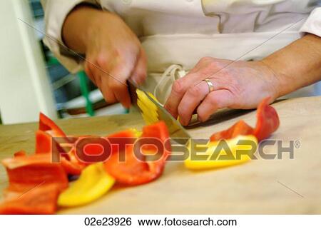 Hands cutting red and yellow peppers in kitchen. View Large Photo Image Stock Photograph - Hands cutting red and yellow peppers in kitchen.. Fotosearch