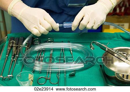 Picture - Hands holding surgical instruments.. Fotosearch