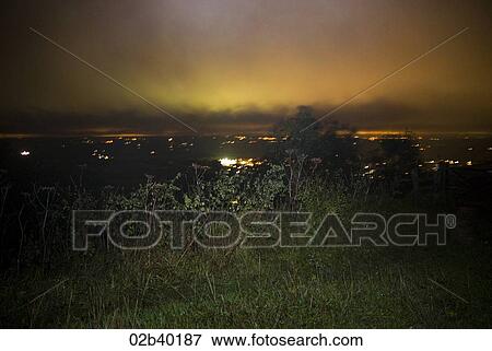 Stock Photo - Hilltop view overlooking city at night. Fotosearch