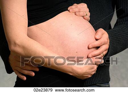 Husband and wife hold mom's belly. View Large Photo Image Stock Photo - Husband and wife hold mom's belly.. Fotosearch