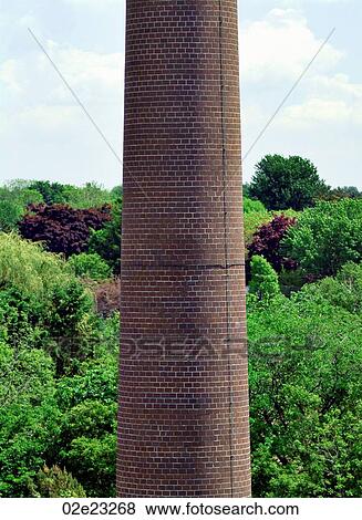 Industrial smoke stack in front of green forest. View Large Photo Image Stock Photo - Industrial smoke stack in front of green forest.. Fotosearch