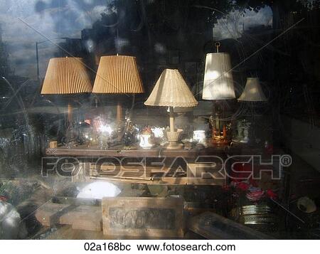 Lamps and other clutter in a dirty antique shop window, horizontal View Large Photo Image Stock Image - Lamps and other clutter in a dirty antique shop window, horizontal. Fotosearch