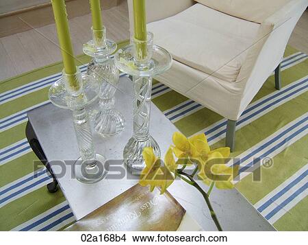 Living room table with candlesticks and armchair on a striped rug View Large Photo Image Picture - Living room table with candlesticks and armchair on a striped rug. Fotosearch