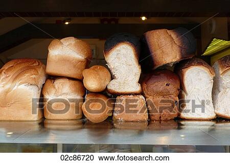 Loaves of fresh bread piled on a bakery counter. View Large Photo Image Stock Image - Loaves of fresh bread piled on a bakery counter.. Fotosearch