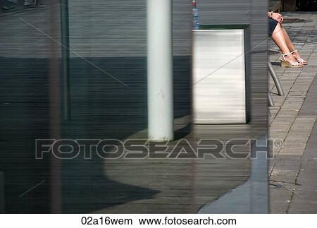 Low section of young woman sitting in bus stop, Ireland, Cork View Large Photo Image Picture - Low section of young woman sitting in bus stop, Ireland, Cork. Fotosearch