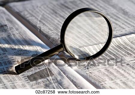 Magnifying glass highlighting investment stock quotes in business section of newspaper. View Large Photo Image Stock Photo - Magnifying glass highlighting investment stock quotes in business section of newspaper.. Fotosearch