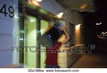 Man carrying a large speaker down the street at night View Large Photo Image Stock Image - Man carrying a large speaker down the street at night. Fotosearch