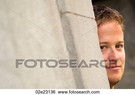 Man hiding around corner of building. View Large Photo Image Stock Photograph - Man hiding around corner of building.. Fotosearch