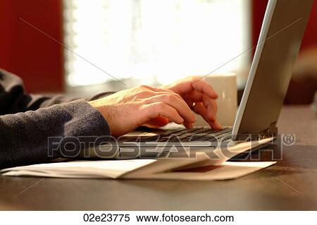 Man using laptop in home office. View Large Photo Image Stock Photography - Man using laptop in home office.. Fotosearch