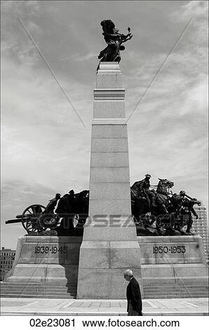 Man walking past War Memorial, Ottawa Canada. View Large Photo Image Stock Image - Man walking past War Memorial, Ottawa Canada.. Fotosearch