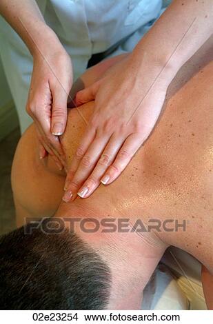 Massage therapist giving spa treatment. View Large Photo Image Picture - Massage therapist giving spa treatment.. Fotosearch
