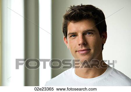 Stock Photography - Mid 20's Caucasian man in white t-shirt.. Fotosearch