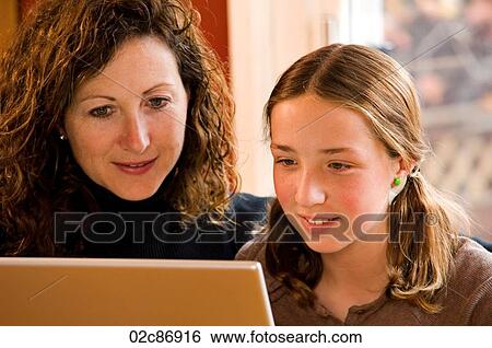 Stock Photograph - Mom and daughter working on computer laptop.. Fotosearch