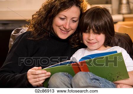 Stock Image - Mom and son reading a book.. Fotosearch