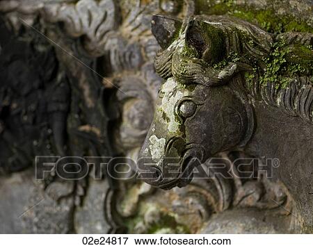 Stock Photo - Moss covered sculpture in Bali. Fotosearch