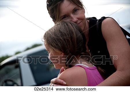 Mother hugging daughter in Belize View Large Photo Image Picture - Mother hugging daughter in Belize. Fotosearch