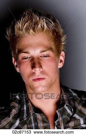 Stock Image - Mysterious lighting on young man's face.. Fotosearch