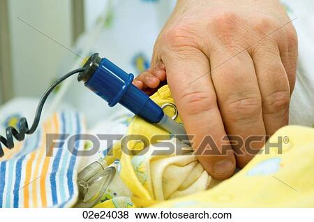 Neo-natal nurse using a baby thermometer. View Large Photo Image Stock Photo - Neo-natal nurse using a baby thermometer.. Fotosearch