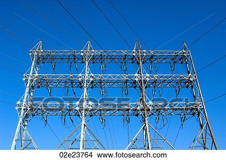 Network of power lines against a blue sky. View Large Photo Image Picture - Network of power lines against a blue sky.. Fotosearch