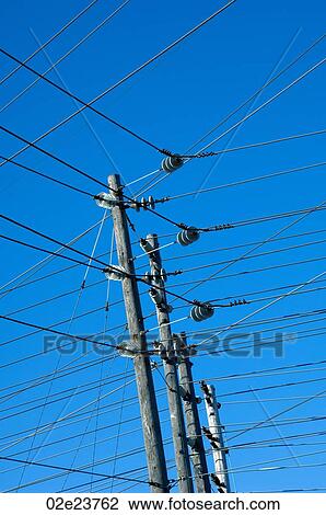 Network of power lines against a blue sky. View Large Photo Image Stock Image - Network of power lines against a blue sky.. Fotosearch