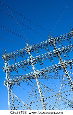 Network of power lines against a blue sky. View Large Photo Image Stock Image - Network of power lines against a blue sky.. Fotosearch