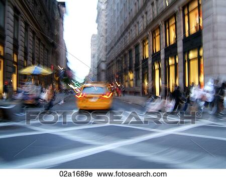 Stock Image - New York City street in motion with yellow cab. Fotosearch