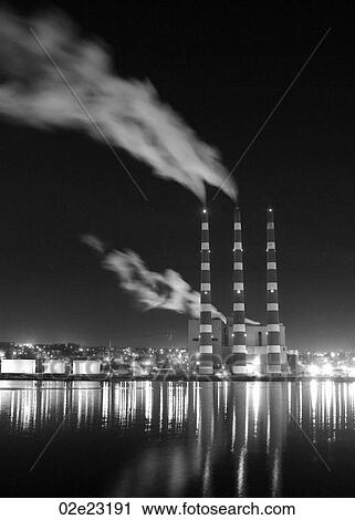 Night shot of Industrial smoke stacks reflecting on water. View Large Photo Image Stock Image - Night shot of Industrial smoke stacks reflecting on water.. Fotosearch