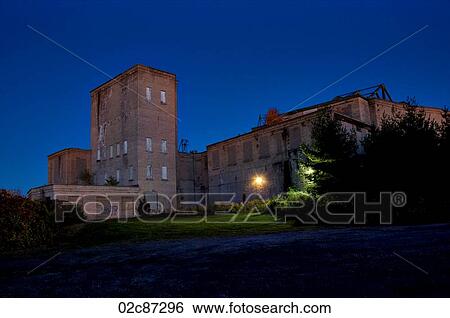 Stock Photograph - Old eerie abandoned warehouse at night.. Fotosearch
