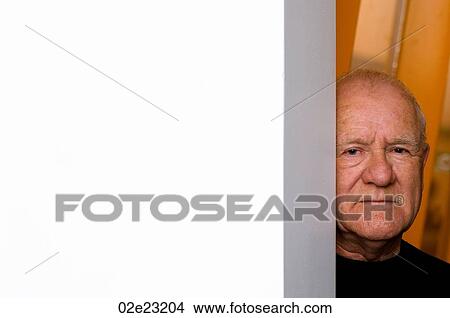 Old man hiding around corner of wall. View Large Photo Image Picture - Old man hiding around corner of wall.. Fotosearch