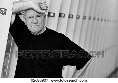 Stock Photo - Older senior man leaning on wall.. Fotosearch